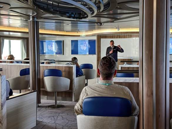 AE Expeditions, Guest watching a lecture, Greg Mortimer, David Stock @ Divergent Travelers.jpg